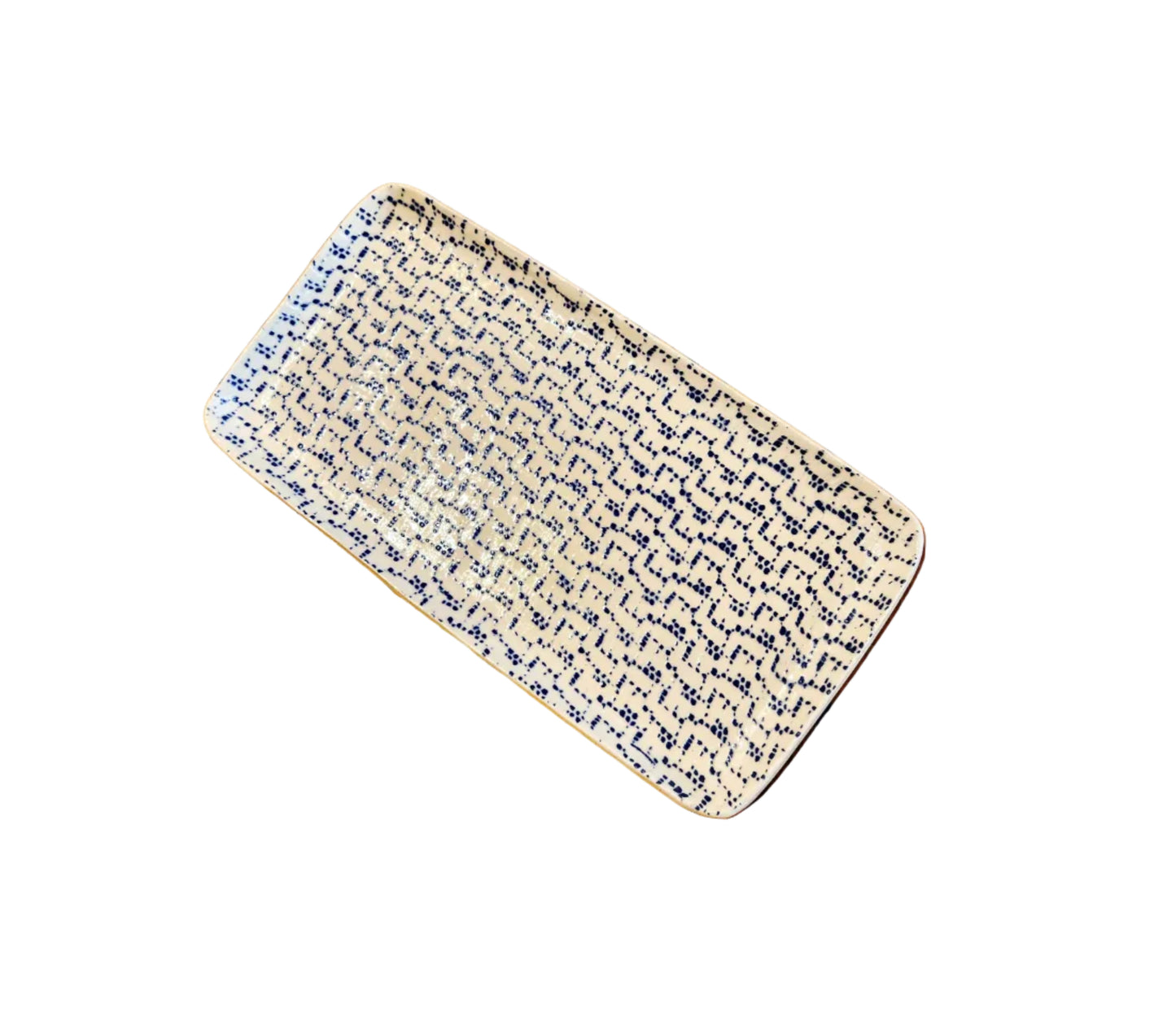 A rectangular ceramic tray with rounded corners, featuring a cream-colored glaze decorated with a dense, dark blue abstract wavy pattern, shown on a rustic wooden plank floor.