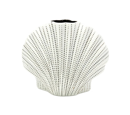 White vase with black dot pattern on a white background