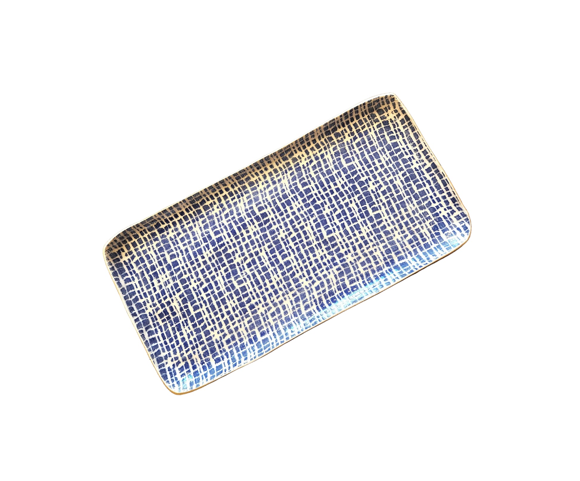A rectangular ceramic serving platter with a blue and white grid pattern and gold accents, displayed diagonally on a rustic wooden surface.