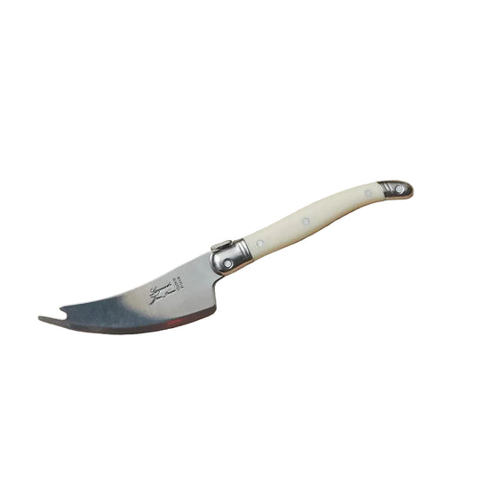 Folding knife with a cream handle on a wooden surface