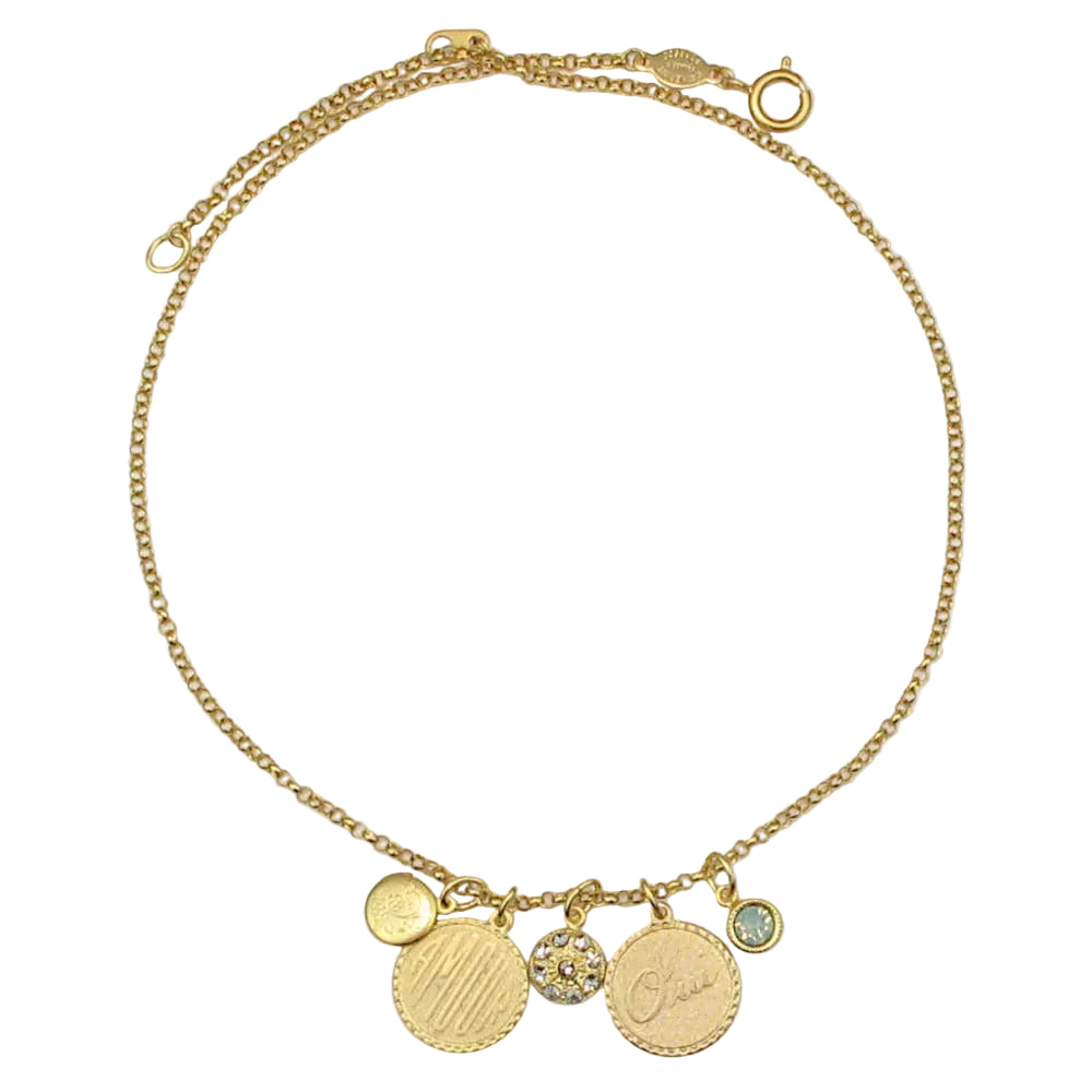 Gold necklace with various charms on a light gray background