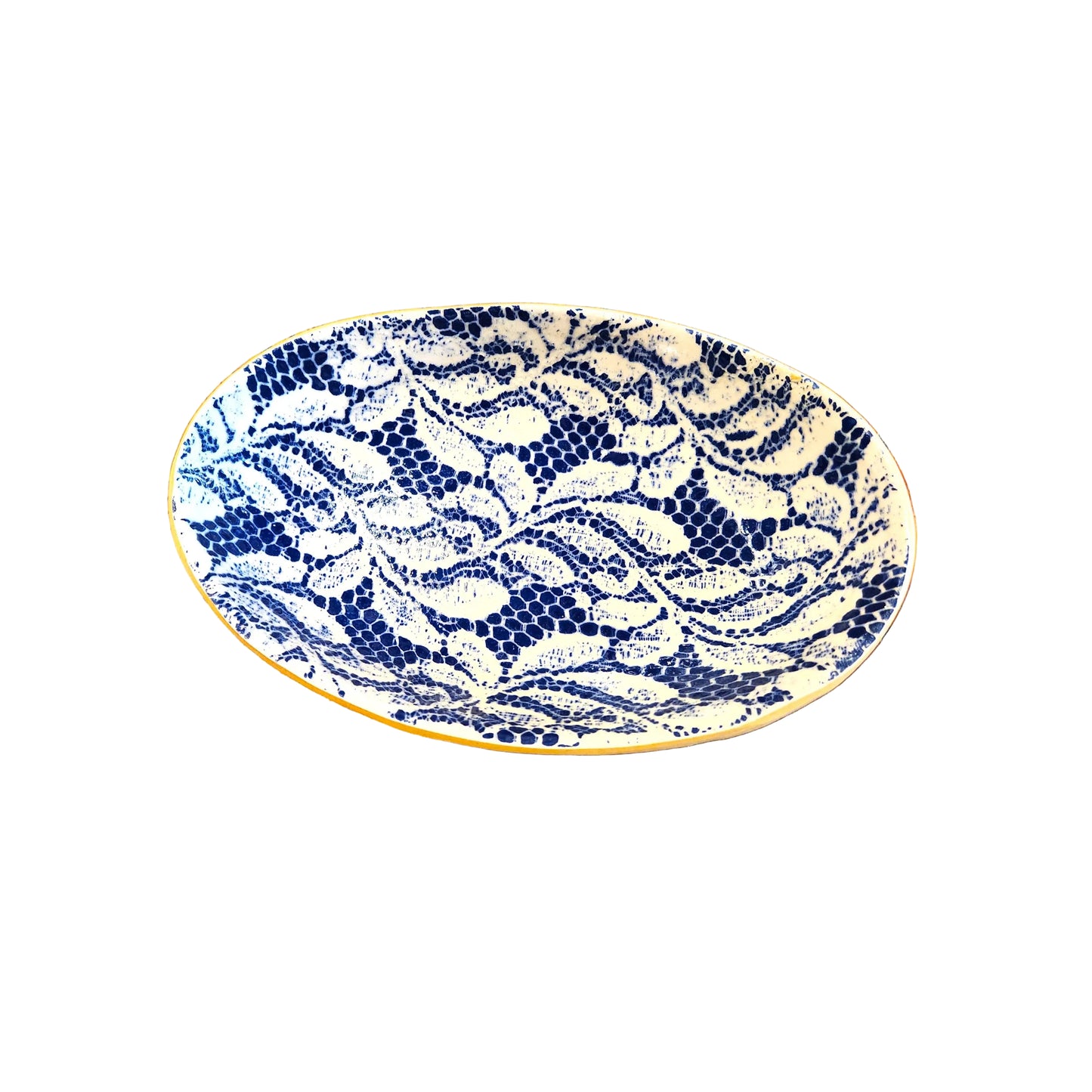 An oval ceramic serving platter with a blue and white floral pattern, resting on a rustic wooden surface.