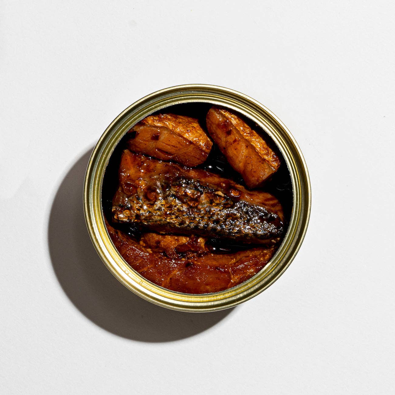 Canned food with fish on a white background