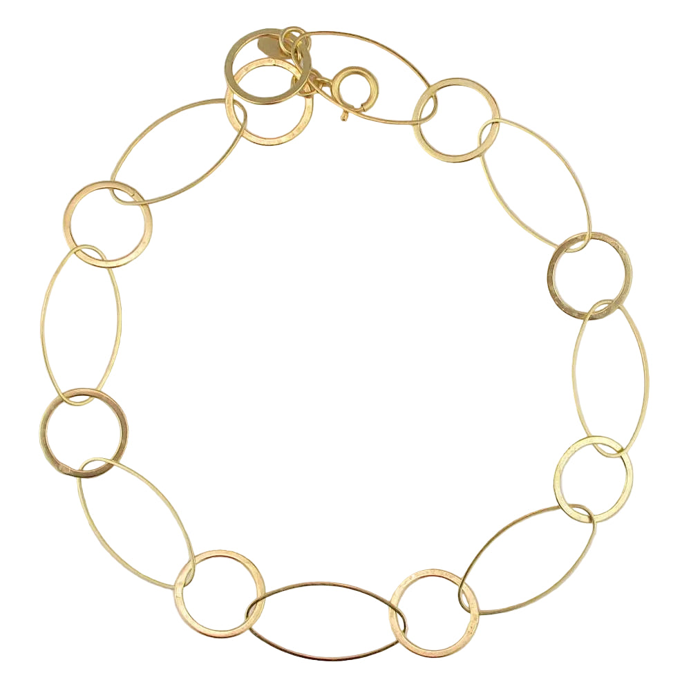 Gold chain bracelet on a light gray background