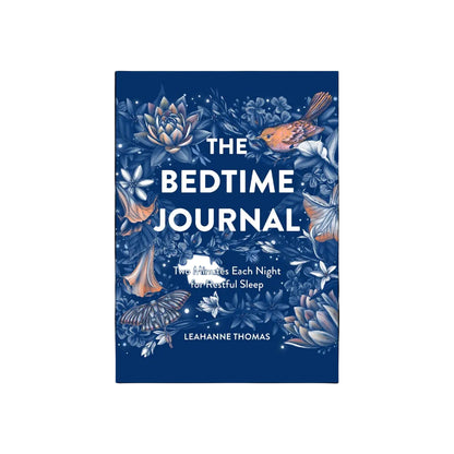 Book cover of 'The Bedtime Journal' with floral design and text on a dark blue background