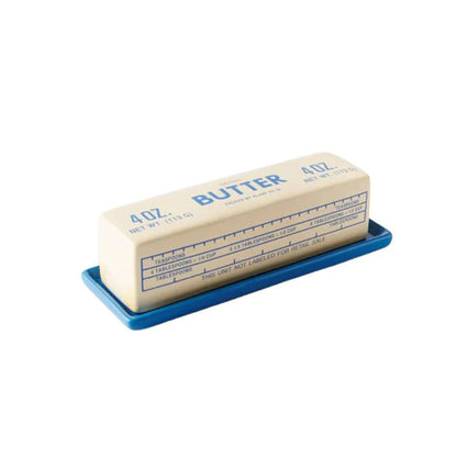 A 4 oz stick of butter resting on a blue plastic measuring tray, shown against a plain white background.