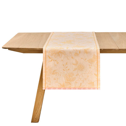Wooden table with a decorative beige runner on a white background