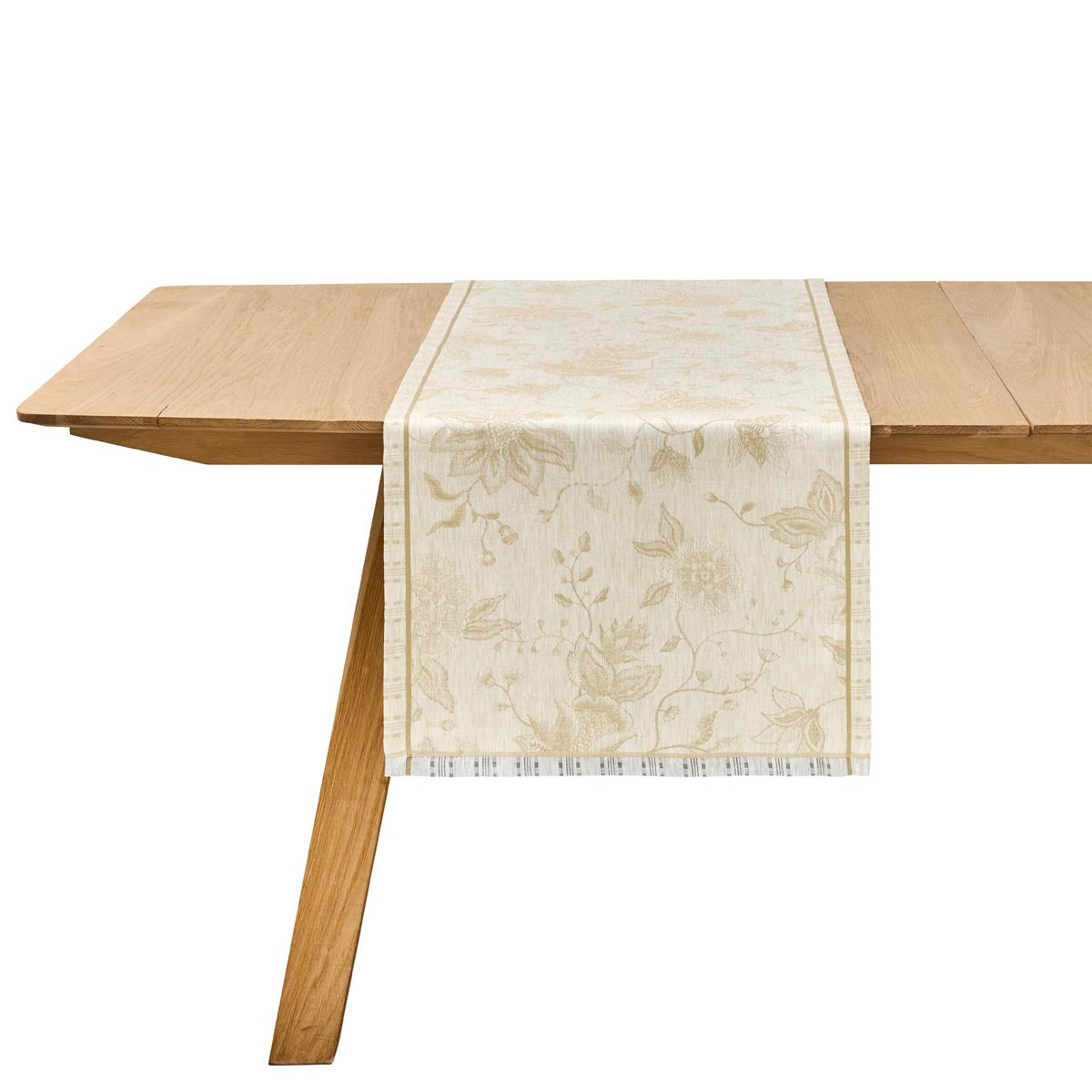 Wooden table with a floral-patterned table runner on a white background