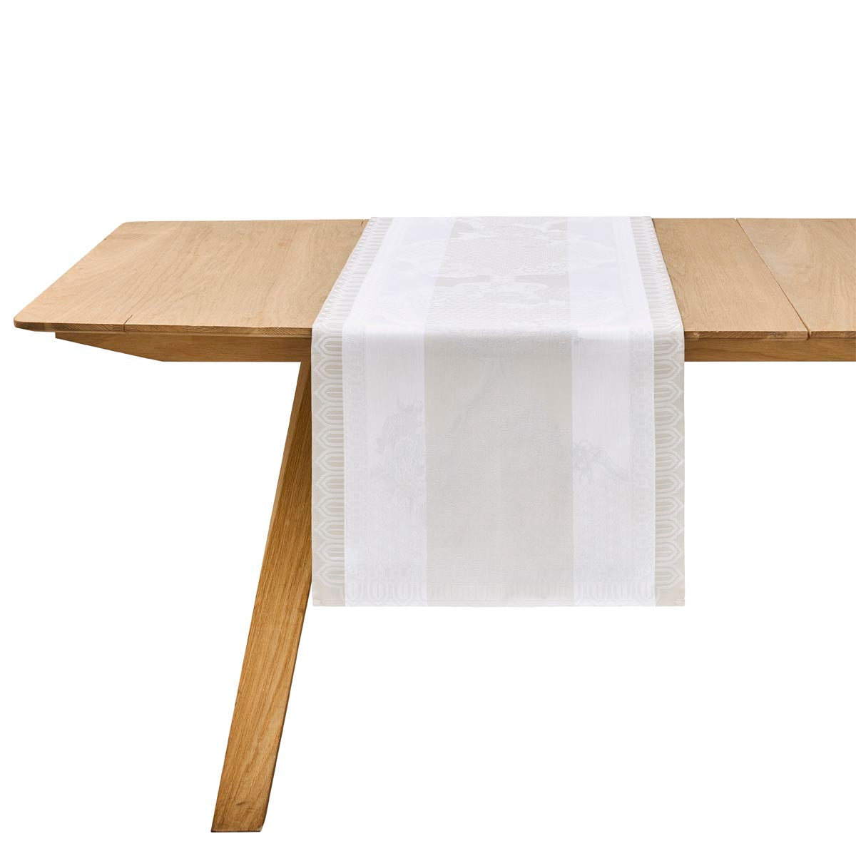 Wooden table with a white table runner on a white background