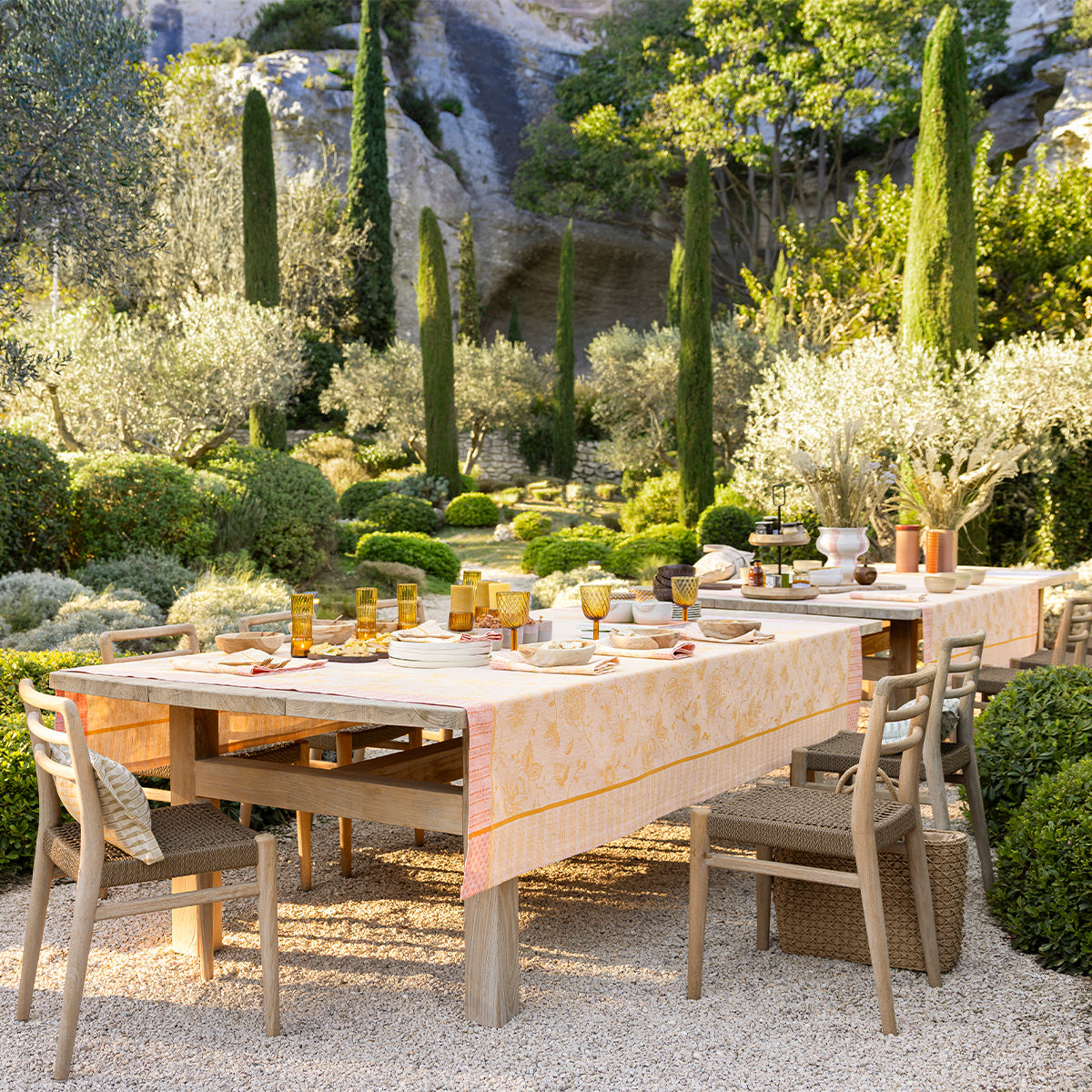 Outdoor dining setup with tables and chairs in a garden setting