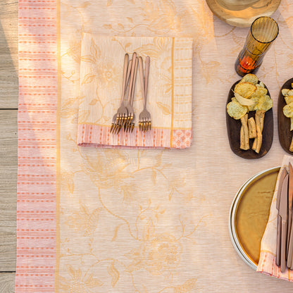 Table setting with cutlery, napkins, and appetizers on a textured surface
