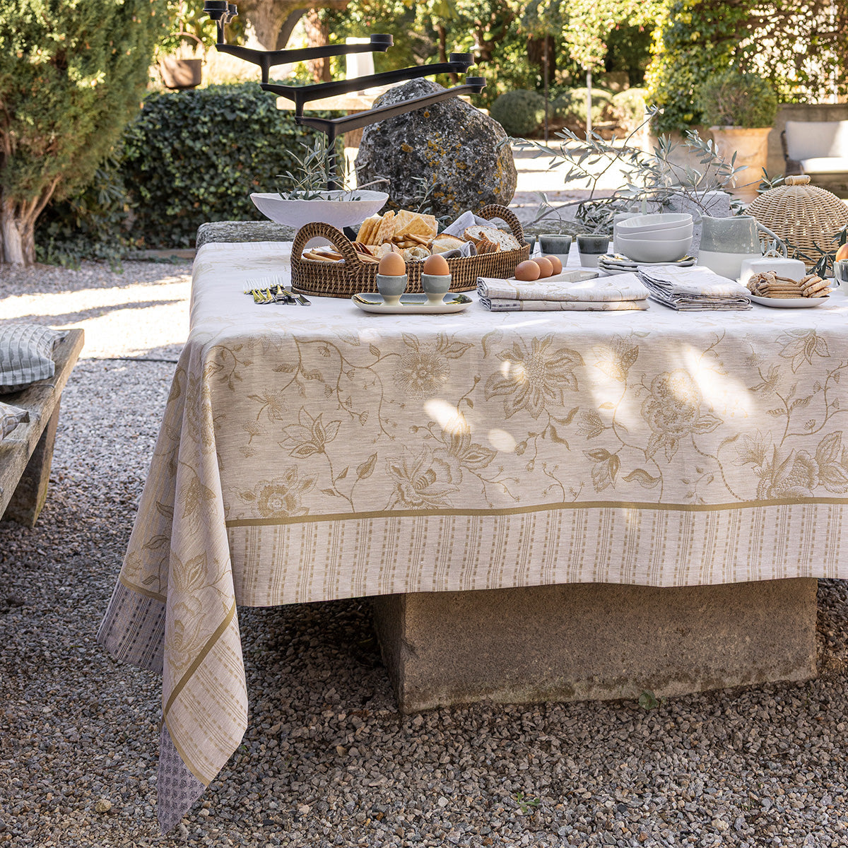 Outdoor table setting with a floral tablecloth in a garden