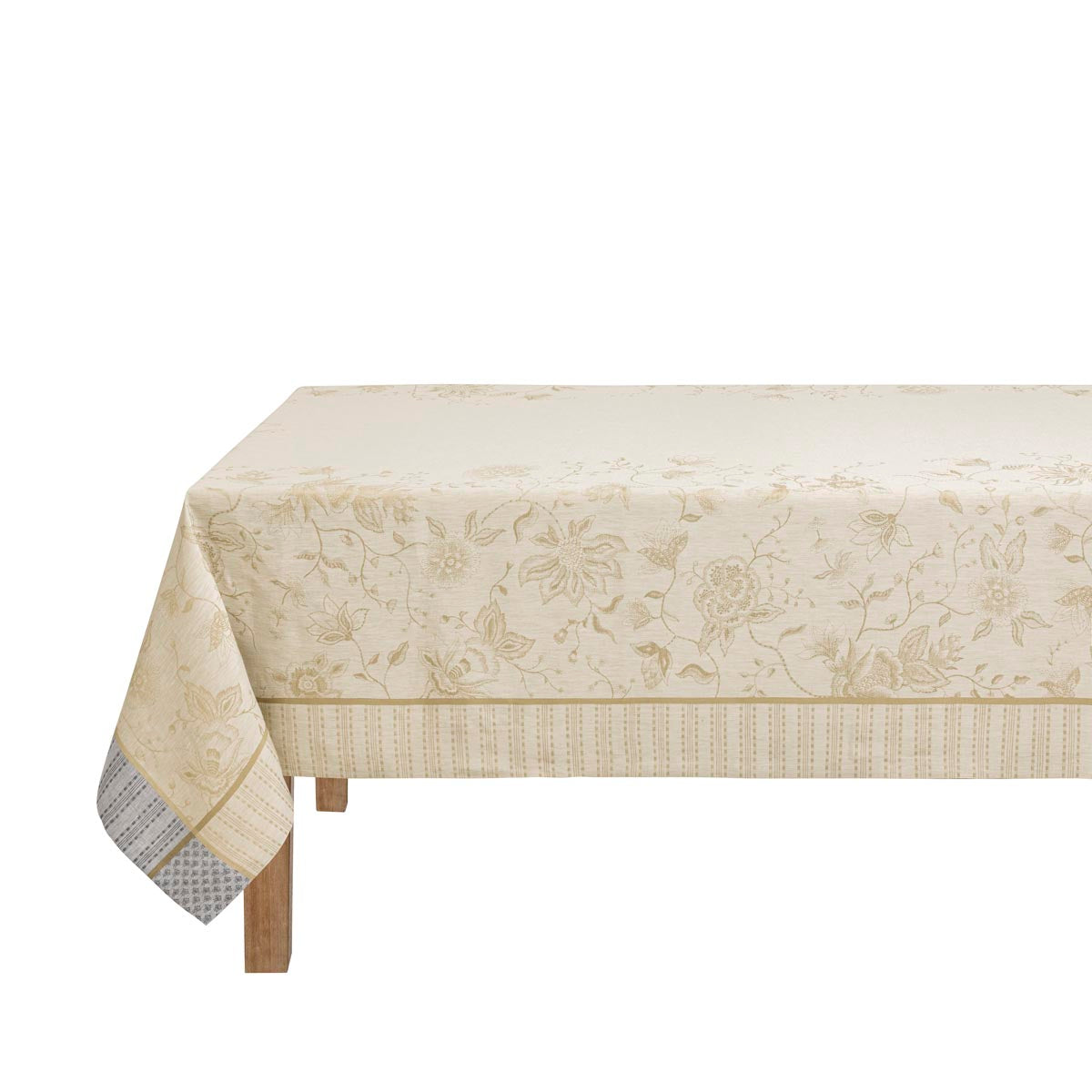 Beige floral patterned tablecloth on a wooden table with a white background