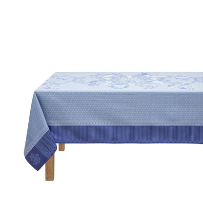 Blue patterned tablecloth on a wooden table with a white background