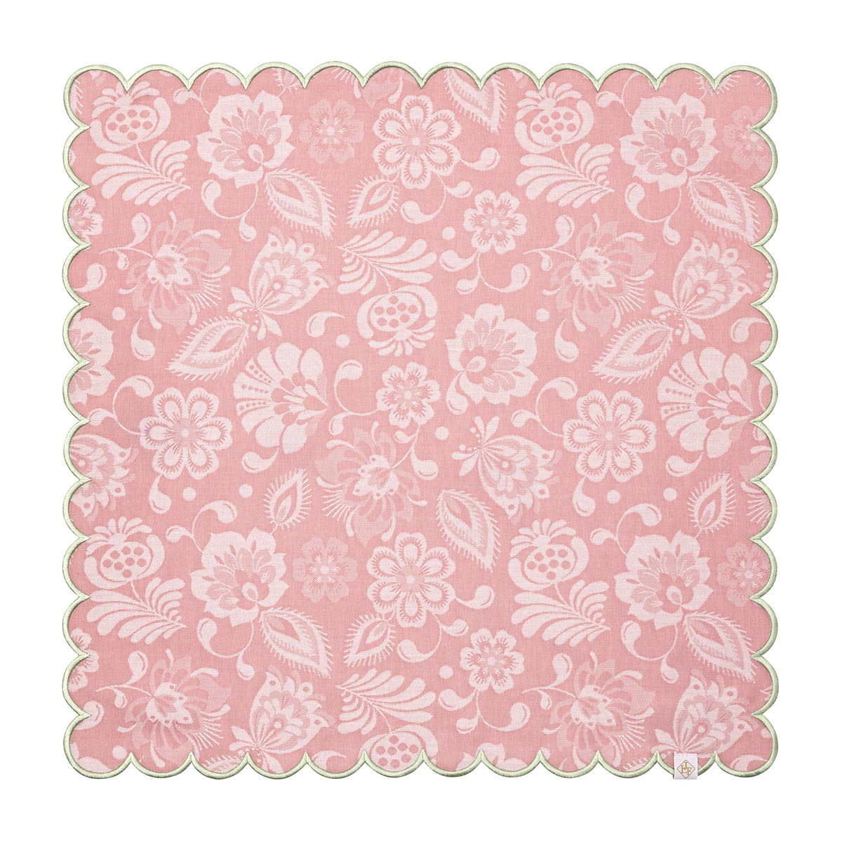 Pink paper doily with white floral pattern