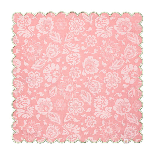 Pink paper doily with white floral pattern