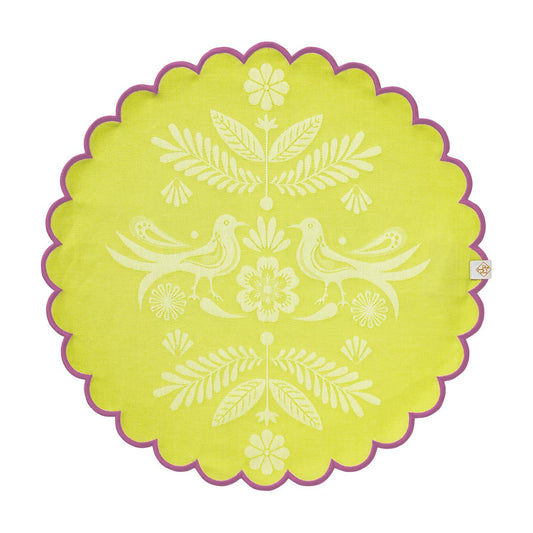 Round green placemat with white floral and bird design on a white background