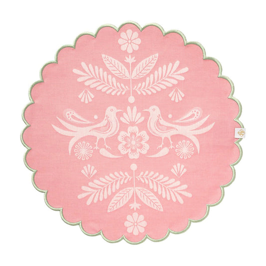 Decorative pink circular design with white floral and bird patterns on a white background