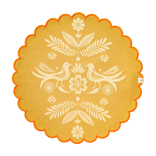Decorative round mat with floral and bird pattern on a beige background