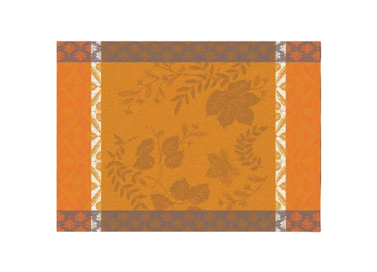 A square decorative pattern tile featuring a central mustard-orange field with muted brown leafy vine motifs, bordered by orange panels and gray-and-white patterned bands.