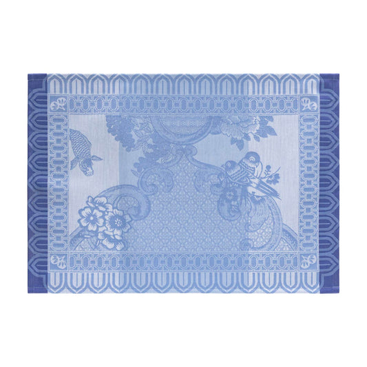 Decorative blue placemat with floral and paisley patterns on a white background