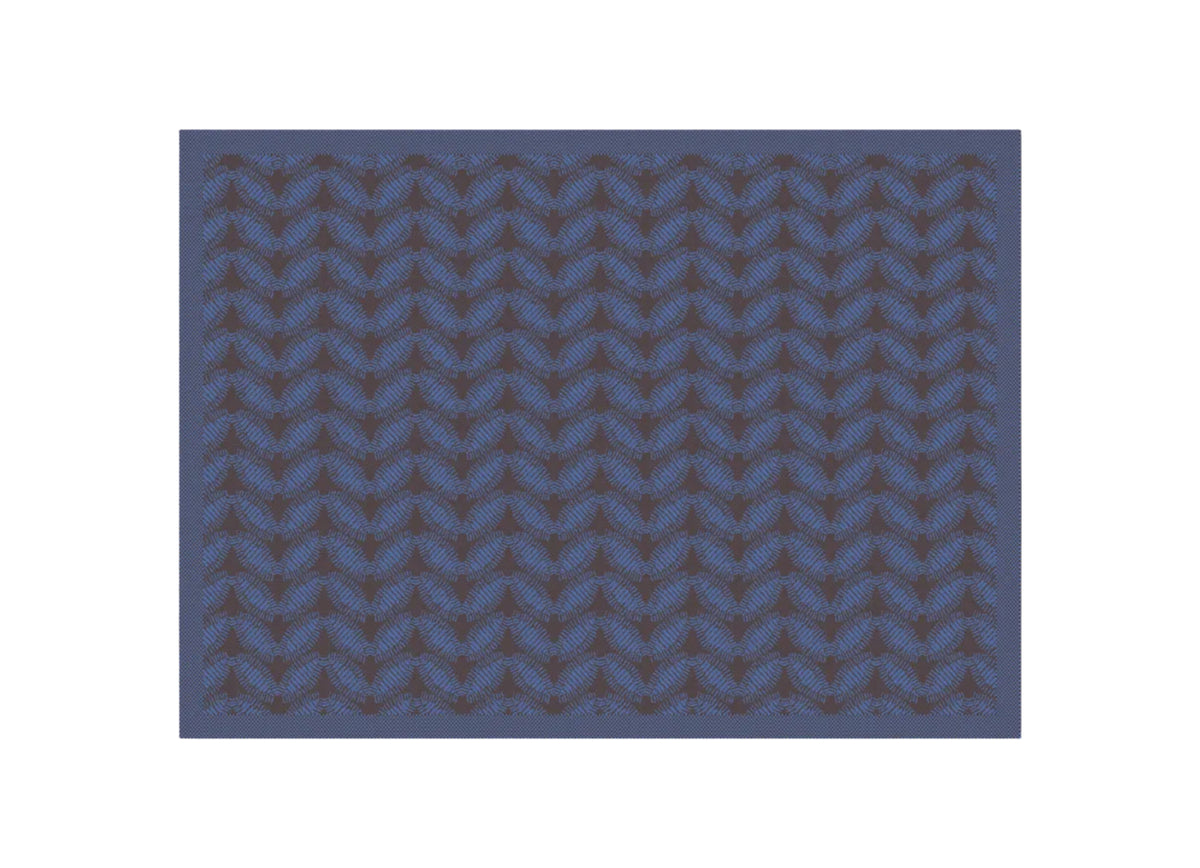A close-up of a repeating fabric pattern featuring blue and dark brown wavy, leaf-like motifs on a solid blue background.