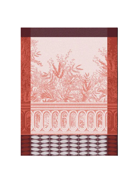 A decorative wallpaper or fabric pattern featuring a terracotta red toile-style botanical design on a pale pink background, framed by rust-red borders with arch motifs and a geometric pattern at the bottom.